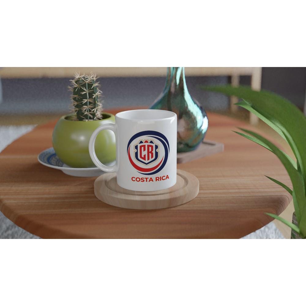 White mug with Costa Rica logo on a wooden table with plants