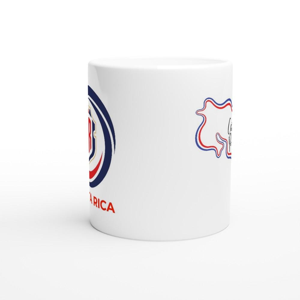 White mug with red, blue, and black designs on a white background