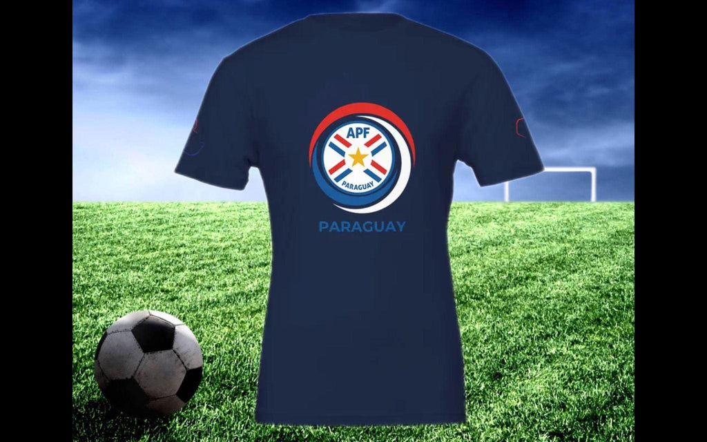 Navy blue t-shirt with a logo and 'Paraguay' text on a grass field with a soccer ball and goalpost.