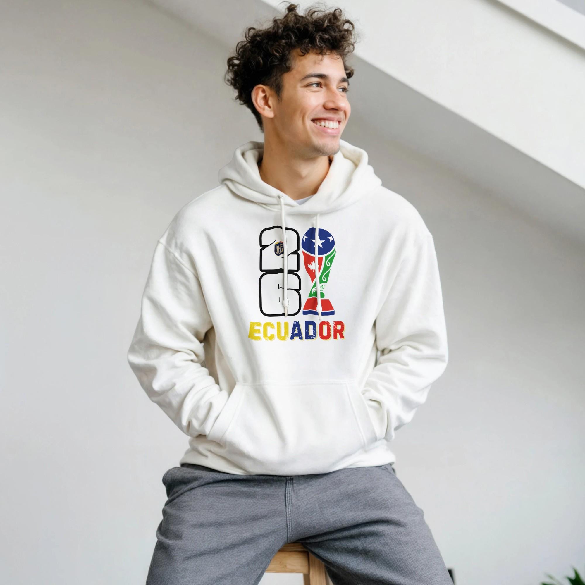 Person wearing a white hoodie with colorful 'Ecuador' design on a light background