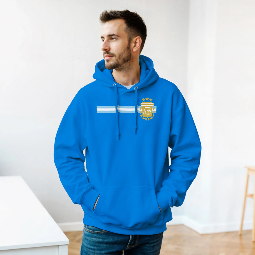Man wearing a blue hoodie with a logo in a minimal indoor setting